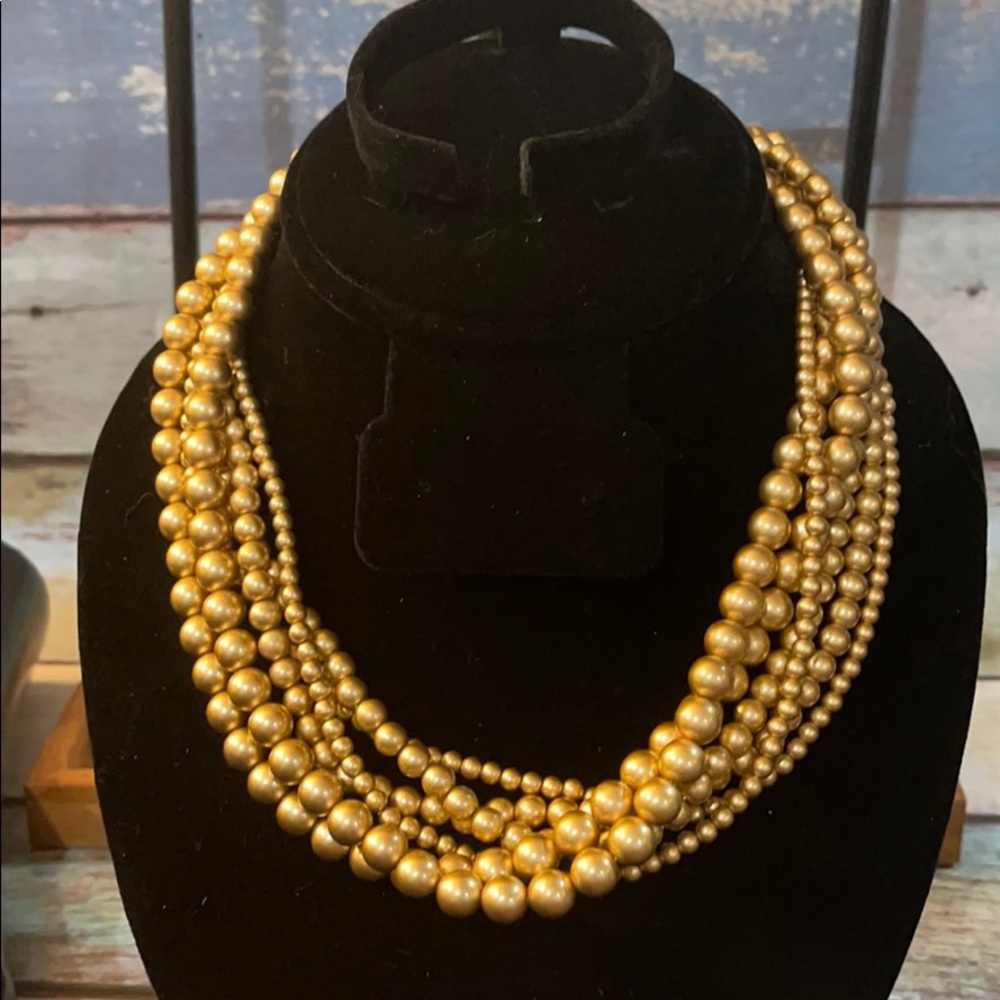 Costume jewelry six chain gold colored necklace